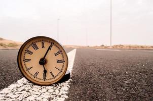 Clock on the road photo