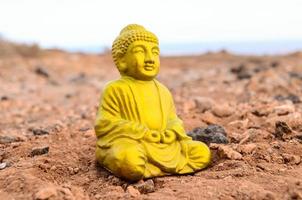 Buddha miniature on the ground photo