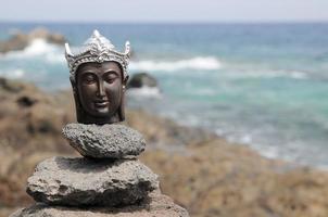 Buddha miniature on the ground photo