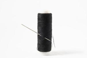 Sewing thread on white background photo