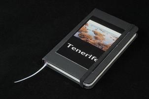 Tenerife book diary on black background photo