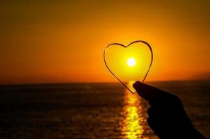 Heart shape over the sunset photo