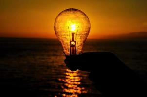 Light bulb over the sunset photo