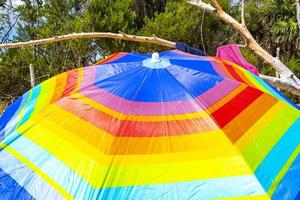 Colorful parasol with many colors on the beach in Mexico. photo