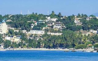 Sun beach people waves and boats in Puerto Escondido Mexico. photo