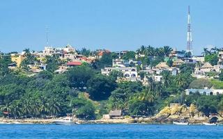 Sun beach people waves and boats in Puerto Escondido Mexico. photo