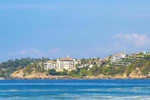 Beach sand blue water huge surfer waves Puerto Escondido Mexico. photo