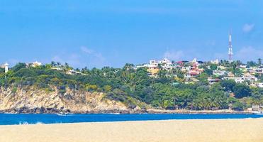 Beach sand blue water huge surfer waves Puerto Escondido Mexico. photo