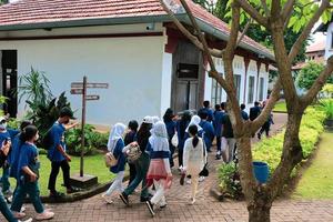 Semarang,December 2022.Semarang, December 2022. The atmosphere of a student tour group together with a tour guide looks at the history of the Lawang Sewu Seribu Pintu building. photo