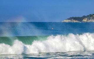 Extremely high huge waves with rainbow in Puerto Escondido Mexico. photo