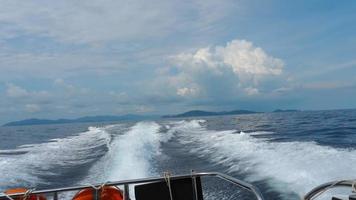 Rear view of a boat floating on the sea ocean with waves in water video