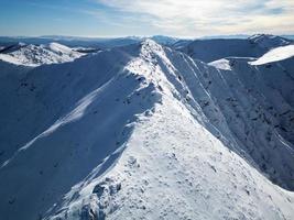 Amazing view of different mountain peaks with snow during winter. Beautiful mountain range and amazing attraction for alpine climbers. Adventurous lifestyle. Challenging mountain ridge for climbers. photo