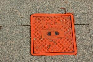 Manhole cover of the gas pipeline system. A massive metal hatch for access to city communications in the pavement. photo