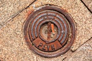 Manhole cover of the gas pipeline system. A massive metal hatch for access to city communications in the pavement. photo