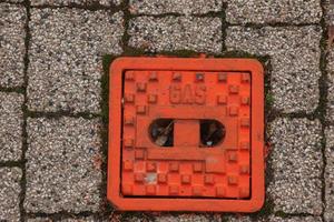 Manhole cover of the gas pipeline system. A massive metal hatch for access to city communications in the pavement. photo