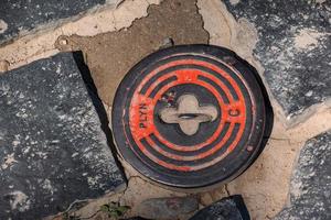 Manhole cover of the gas pipeline system. A massive metal hatch for access to city communications in the pavement. photo