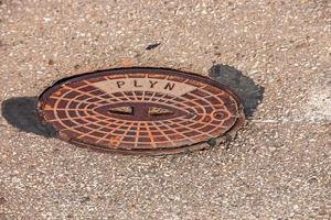 Manhole cover of the gas pipeline system. A massive metal hatch for access to city communications in the pavement. photo