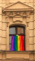 Pride of the LGBT rainbow flag in the city of Bratislava. View of the window of a building with a rainbow flag. photo