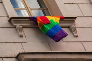 Pride of the LGBT rainbow flag in the city of Bratislava. View of the window of a building with a rainbow flag. photo