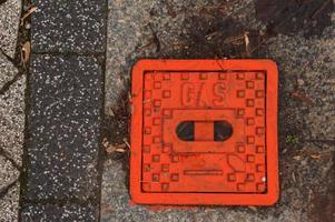 Manhole cover of the gas pipeline system. A massive metal hatch for access to city communications in the pavement. photo