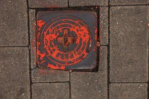 Manhole cover of the gas pipeline system. A massive metal hatch for access to city communications in the pavement. photo