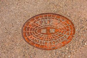 Manhole cover of the gas pipeline system. A massive metal hatch for access to city communications in the pavement. photo