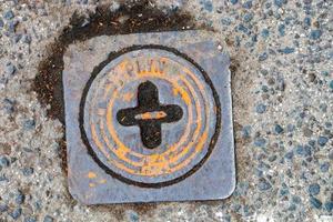 Manhole cover of the gas pipeline system. A massive metal hatch for access to city communications in the pavement. photo