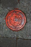 Manhole cover of the gas pipeline system. A massive metal hatch for access to city communications in the pavement. photo