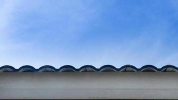 Abstract of roof eaves with wooden slats covering the bottom. Under the blue sky. Free space for insert text. photo