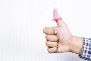 Condom ready to use in young man hand, give condom safe sex hand fondle touch zip pants. concept  Prevent infection and Contraceptives control the birth rate or safe prophylactic. World AIDS Day