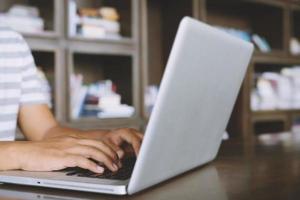 attractive confident two business women in smart working on laptop creative in her work station. and woman hand holding a pen and is working on the Graphic designer note pad of the notebook screen. photo