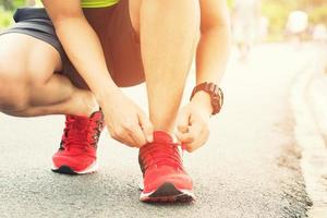 Running shoes. Barefoot running shoes closeup. male athlete tying laces for jogging on road. Runner ties getting ready for training. Sport lifestyle. photo