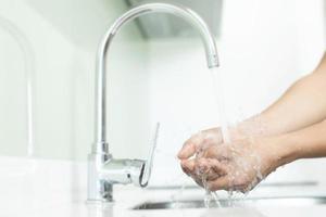 Cleaning Hands. Washing hands with soap under the faucet with water Pay dirt. photo