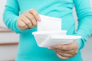 Female Hygiene. Close Up Young woman holding a Clean Period slim sanitary napkin pad. Reports daily menstrual period day use on every month. Feminine Intimate Product. health care concept. photo