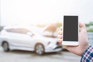 close up businessman hand using a mobile smart phone call a car mechanic ask for help assistance because car broken roadside. people journey friends standing wait beside broken car background photo