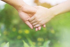 Woman and man holding Shake hands, Happy couple love in the garden. concept couple lover valentine day. photo