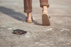 businessman had lost leather wallet with money on the street. Close-up of wallet lying on the sidewalk in during the trip to work. Leave space for writing messages. photo