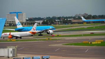 AMSTERDAM, THE NETHERLANDS JULY 29, 2017 - TUI Airlines Netherlands Boeing 737 C GOWG and KLM Royal Dutch Airlines Boeing 777 PH BQO taxiing to the start. Shiphol Airport, Amsterdam, Holland video