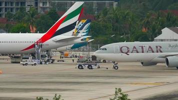 PHUKET, THAILAND DECEMBER 26, 2016 - Qatar Airways Airbus 330 A7 ACI towing before departure. View from the top floor of the hotel Centara Grand West Sands Resort Phuket video