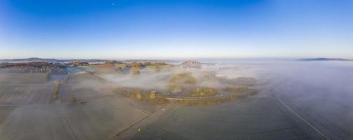 Drone image of morning ground fog over fields in the German province of North Hesse near the village of Rhoden photo