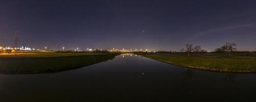 Panoramic aerial view on illuminated skyline of Fort Worth over West Fork Trinity River at night photo