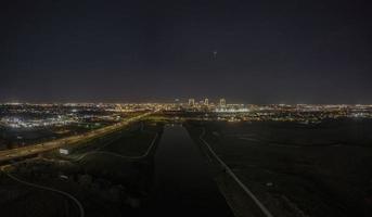 Panoramic aerial view on illuminated skyline of Fort Worth over West Fork Trinity River at night photo