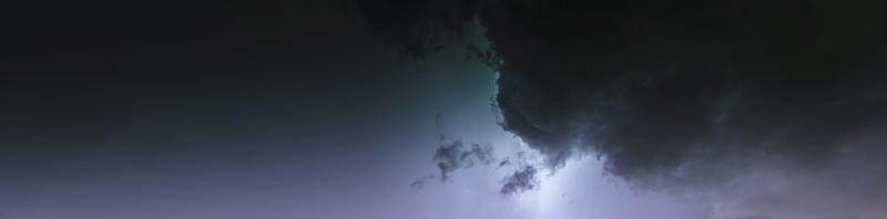 Picture of a flash in the night sky with glowing clouds photo