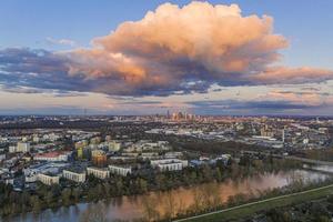 Aerial panoramic picture of river Main and the Frankfurt skyline during sunset in afterglow with illuminated cloud photo