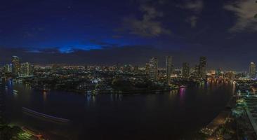 Panoramic aerial night picture of the Bangkok skyline and Chao Phraya river photo