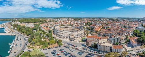 Drone panorama of the Croatian coastal city of Pula taken during the day above the harbor photo
