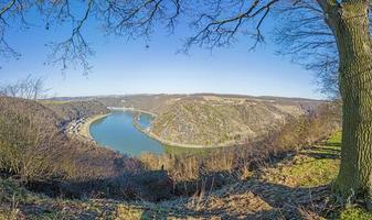 Panoramic image of the Loreley rock on the Rhine river taken from the opposite side of the Rhine under blue sky and sunshine photo