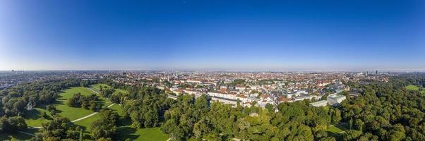 Panoramic aerial drone picture of Munich taken from English garden in the morning time photo