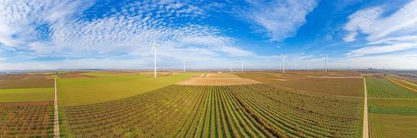 Panoramic aerial photo of a wind farm in Germany with blue sky and light clouds