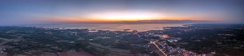 Drone panorama over Istrian Adriatic coast near Porec taken from high altitude at sunset photo